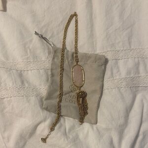 Kendra Scott long gold tassel necklace with pink jewel